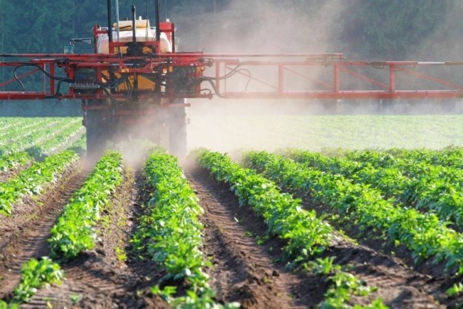 machine spreads pesticides on field effects drinking water