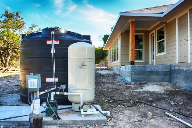 Private deep well water well set up in front construction house