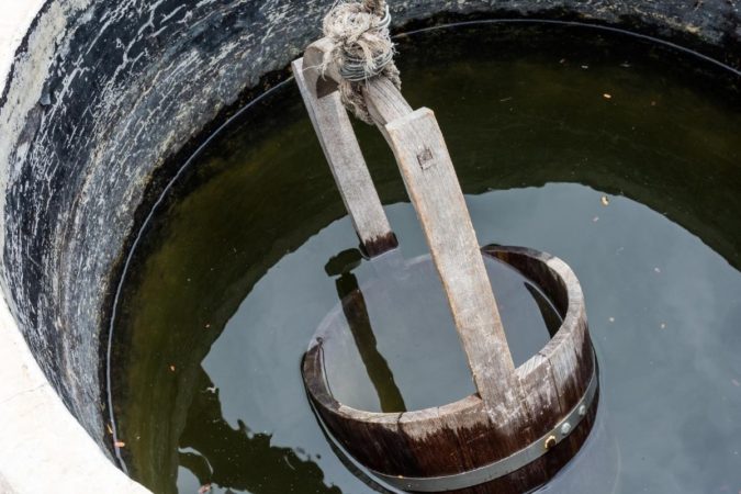 Bucket With Black Sediment In Well Water
